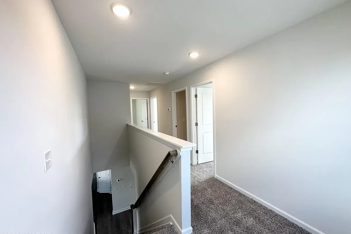https://assets.windsorhomes.us/img/GRY_lot150_Cameron_B_7841_Waterwillow_Dr_stairs.webp